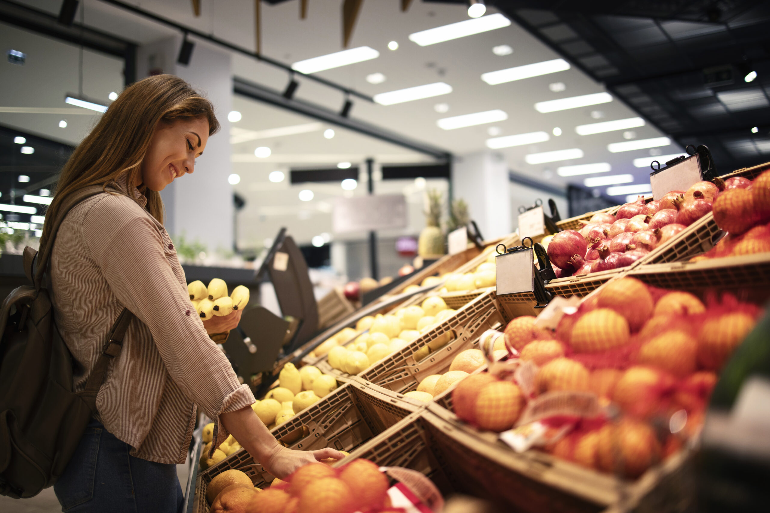 Female buying fruit at supermarket.